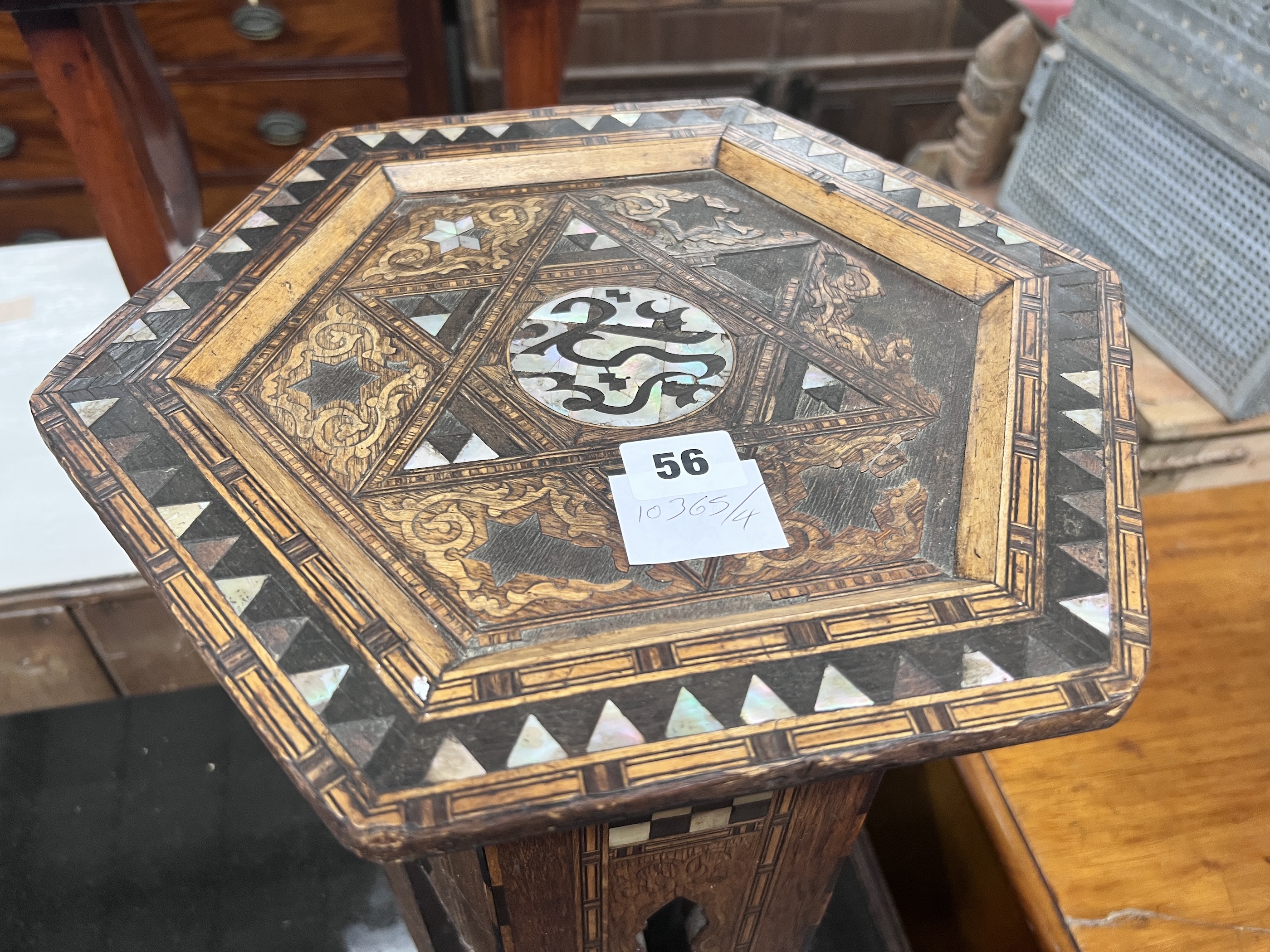 A Moorish mother of pearl inlaid hexagonal occasional table, width 32cm, height 46cm